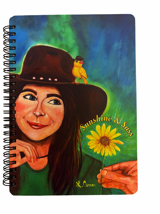Notebook with colorful design of women in a cowboy hat, a yellow bird and sunflower