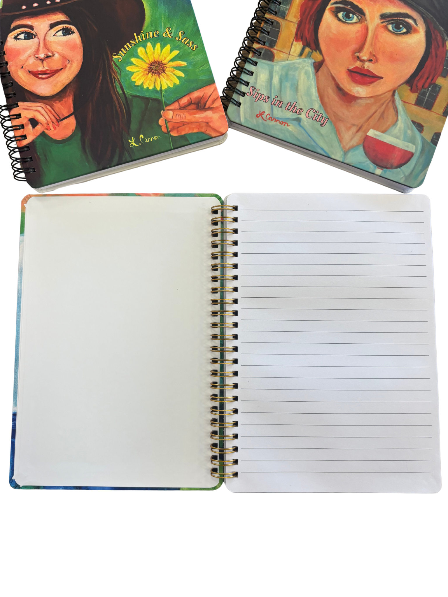 Open lined notebook displayed with the Sips in the City and Sunshine & Sass art notebook covers above it; feminine illustrated journals from the Femmes & Feathers collection shown with interior pages.