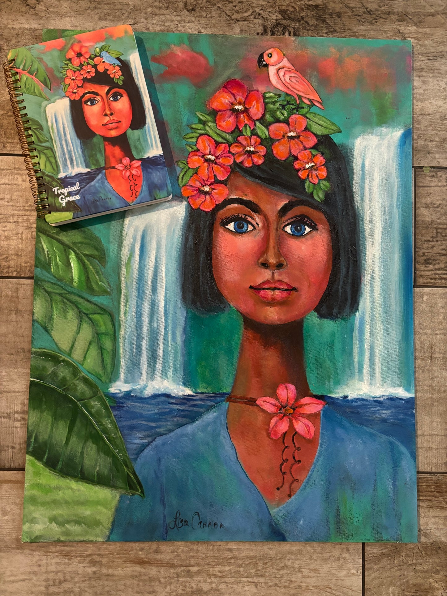 Original Tropical Grace painting with the matching art notebook resting in the upper corner; artistic comparison highlighting the illustrated journal and its source artwork.