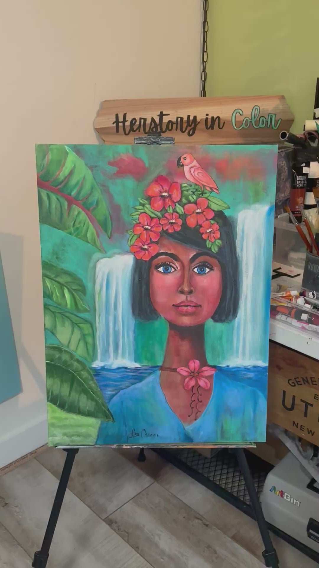 A painting showing original artwork and the notebook made from the painting of a colorful tropical women