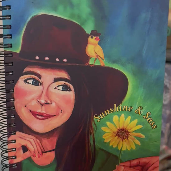 Video of Sunshine and Sass notebook showing the original art turned into a notebook for journaling